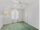 Cozy bedroom with plush carpeting, neutral decor, and a ceiling fan for added comfort at 432 King Way, Tavares, FL 32778