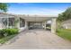 View of the covered carport area with an electric golf cart parked, offering convenience and protection from the elements at 432 King Way, Tavares, FL 32778
