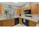 Classic kitchen with black appliances, spacious countertops, and an abundance of natural light at 432 King Way, Tavares, FL 32778