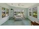 Bright living room featuring large windows, a ceiling fan, and comfortable seating, perfect for relaxation at 432 King Way, Tavares, FL 32778