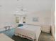 Bright bedroom with a ceiling fan, large window and a king bed and two white dressers at 432 King Way, Tavares, FL 32778