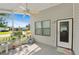 Cozy enclosed porch with a ceiling fan, offering a relaxing outdoor space with views of the neighborhood at 432 King Way, Tavares, FL 32778