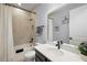 Bathroom with a white shower curtain, vanity with black faucet, and beige tile at 4515 Lions Gate Ave, Clermont, FL 34711