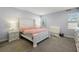 Bright bedroom features a white bed frame, carpet, and plenty of natural light at 4515 Lions Gate Ave, Clermont, FL 34711