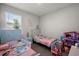 Shared bedroom with twin beds, bright decor, and a playful atmosphere at 4515 Lions Gate Ave, Clermont, FL 34711