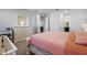 Bright Primary bedroom with large bed, gray carpet, and views from the window at 4515 Lions Gate Ave, Clermont, FL 34711