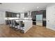 Open kitchen with an island, sleek cabinetry, stainless steel appliances, and hardwood flooring at 4515 Lions Gate Ave, Clermont, FL 34711