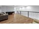 Spacious living area with wood floors, neutral colors, and a wrought iron railing at 4515 Lions Gate Ave, Clermont, FL 34711