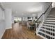 Spacious living room featuring wood floors, a dining area, and an open floor plan flowing into the kitchen at 4515 Lions Gate Ave, Clermont, FL 34711