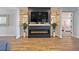Cozy living room with a decorative fireplace, built-in shelving, and an adjacent bedroom at 4515 Lions Gate Ave, Clermont, FL 34711