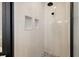 Modern glass shower features sleek tiling, a shower head and niche at 4515 Lions Gate Ave, Clermont, FL 34711
