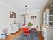Cozy dining area with vintage-style table, red chairs, and hardwood floors at 500 Newell Hill Rd # 111A, Leesburg, FL 34748
