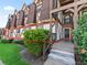 Exterior view of Tudor-style townhome with lush landscaping and private entrance at 500 Newell Hill Rd # 111A, Leesburg, FL 34748