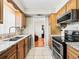 Functional kitchen featuring granite counters, stainless steel appliances and wood cabinets, providing ample cooking space at 500 Newell Hill Rd # 111A, Leesburg, FL 34748
