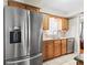 Well-lit kitchen with stainless steel appliances, wood cabinets, and granite countertops at 500 Newell Hill Rd # 111A, Leesburg, FL 34748