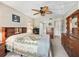 Comfortable primary bedroom with tiled floors, neutral walls, and ample furniture creating a restful space at 500 Newell Hill Rd # 111A, Leesburg, FL 34748