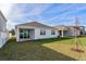 A newly seeded backyard features a covered patio and view of the back of the home at 5024 Balsam Falls Rd, Deland, FL 32724