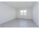 Bright, neutral bedroom with a large window, offering plenty of natural light and a serene atmosphere at 5024 Balsam Falls Rd, Deland, FL 32724