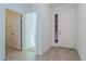 Bright entryway featuring wood-look tile flooring and a view into other rooms of the house at 5024 Balsam Falls Rd, Deland, FL 32724
