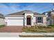 Charming single-story home with a brick driveway, stone accents, and a two-car garage in a well-maintained neighborhood at 5024 Balsam Falls Rd, Deland, FL 32724