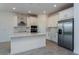 Bright kitchen featuring a large island, stainless steel appliances, and stylish backsplash at 5024 Balsam Falls Rd, Deland, FL 32724