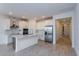 Modern kitchen with white cabinets, stainless steel appliances, tile backsplash, and a central island at 5024 Balsam Falls Rd, Deland, FL 32724
