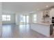 Open floor plan with a modern kitchen, island, and large windows offering ample natural light at 5024 Balsam Falls Rd, Deland, FL 32724