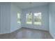Bright dining area with wood-look tile floors and a chandelier hanging above at 5028 Balsam Falls Rd, Deland, FL 32724