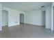 Bright and airy living room with wood-look tile flooring and arched doorways at 5028 Balsam Falls Rd, Deland, FL 32724