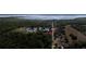 Aerial perspective of the property surrounded by tall trees and the lake nearby at 5029 Eagles Nest Rd, Fruitland Park, FL 34731