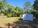 Backyard showcases a storage shed and a manicured lawn at 5029 Eagles Nest Rd, Fruitland Park, FL 34731