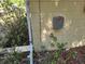 Exterior utility box on a yellow building with foliage nearby at 5029 Eagles Nest Rd, Fruitland Park, FL 34731