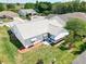Aerial view of a well-kept home featuring a screened lanai and a manicured lawn with garden at 508 Carrera Dr, The Villages, FL 32159