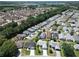 Aerial community view showcasing manicured lawns and proximity to nature and a lake at 508 Carrera Dr, The Villages, FL 32159