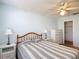Comfortable bedroom with ceiling fan, side tables, and a closet for ample storage space at 508 Carrera Dr, The Villages, FL 32159