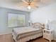Bright bedroom with a ceiling fan and a large window allowing natural light to illuminate the room at 508 Carrera Dr, The Villages, FL 32159