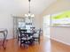 Dining area with wood table, chairs, chandelier, and adjacent kitchen space at 508 Carrera Dr, The Villages, FL 32159