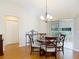This cozy dining room features an elegant chandelier and sliding doors to the outdoor patio at 508 Carrera Dr, The Villages, FL 32159