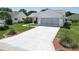 Exterior shot of a single story home featuring a large concrete driveway and manicured landscaping at 508 Carrera Dr, The Villages, FL 32159