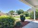 View from covered front porch highlighting mature landscaping and neighborhood views at 508 Carrera Dr, The Villages, FL 32159