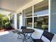 Covered front porch with seating, decorative accents, and view of well-maintained lawn at 508 Carrera Dr, The Villages, FL 32159