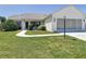 Well-manicured lawn, paved walkway, and green landscaping add charm to this quaint single story home at 508 Carrera Dr, The Villages, FL 32159