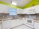 Functional kitchen features white cabinetry, appliances, and ample counter space for cooking at 508 Carrera Dr, The Villages, FL 32159