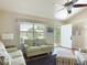 Bright living room with natural light, vaulted ceilings, comfortable seating, and views of the front yard at 508 Carrera Dr, The Villages, FL 32159