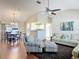 Inviting living room featuring vaulted ceilings, hardwood floors, comfortable seating, and open floor plan at 508 Carrera Dr, The Villages, FL 32159