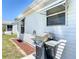Exterior side yard featuring a stainless steel gas grill, perfect for outdoor cooking and entertaining at 508 Carrera Dr, The Villages, FL 32159