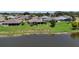 Scenic aerial view of the homes and community with a tranquil lake, showcasing a peaceful neighborhood setting at 5220 Horsford Path, The Villages, FL 32163