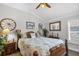 Guest bedroom features a ceiling fan, natural light, and wood-look tile floors at 5220 Horsford Path, The Villages, FL 32163