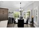 Dining area featuring a round glass table, leather chairs, bar, and natural light at 5220 Horsford Path, The Villages, FL 32163