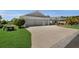 Charming home featuring a three-car garage and well-maintained lawn and landscaping at 5220 Horsford Path, The Villages, FL 32163